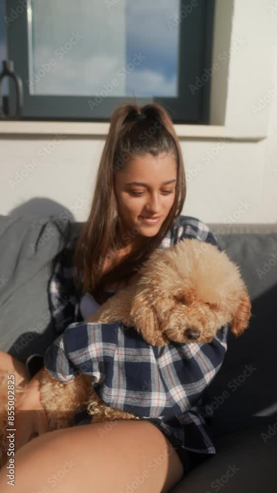 A woman is showing affection to a cute and fluffy dog in a peaceful outdoor setting A woman is showing affection to a cute and fluffy dog in a peaceful outdoor setting