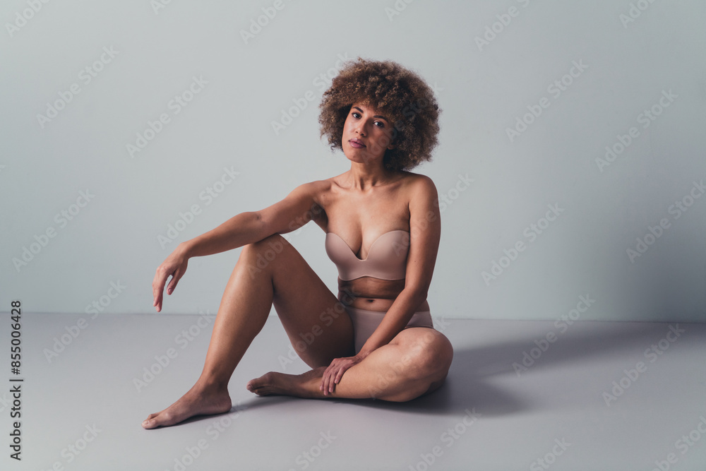 Unretouched photo of girl sitting posing for photo session in comfortable lingerie feel body positive isolated grey color background Unretouched photo of girl sitting posing for photo session in comfortable lingerie feel body positive isolated grey color background