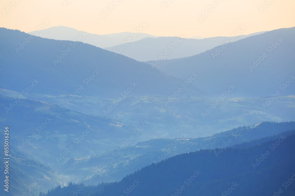 green mountain chain in dense mist under cloudy sky green mountain chain in dense mist under cloudy sky