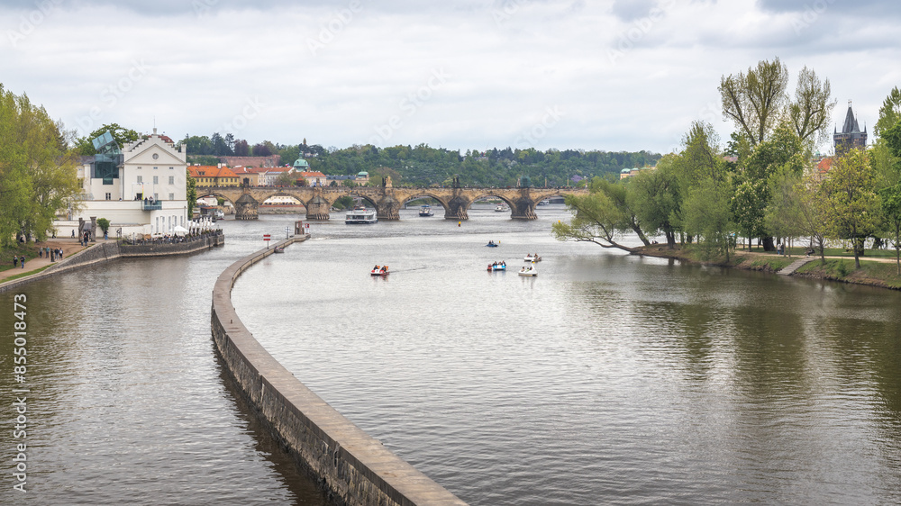The Vltava River with water bikes near the Charles Bridge in Prague, Czech Republic, Europe. The Vltava River with water bikes near the Charles Bridge in Prague, Czech Republic, Europe.