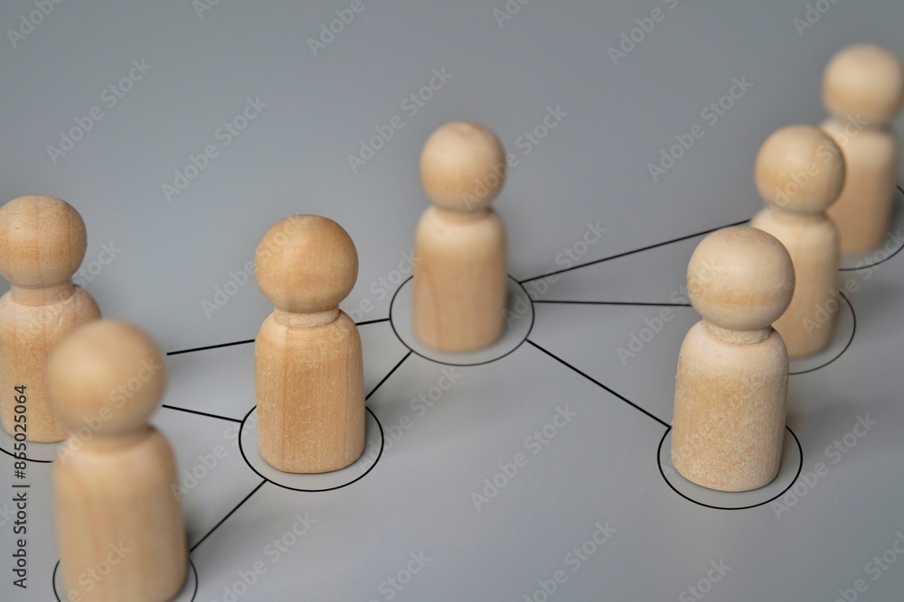 Obraz premium Wooden dolls connected by lines. Cooperation and interaction, disseminating information, rumors concept.