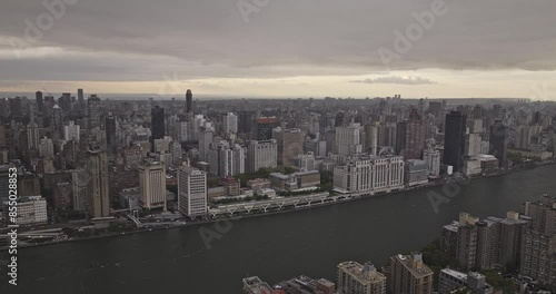 Wallpaper Mural NYC New York Aerial v323 drone flyover East river and Roosevelt Island capturing Upper East Side and Midtown Manhattan cityscape against ominous cloud sky - Shot with Mavic 3 Pro Cine - September 2023 Torontodigital.ca