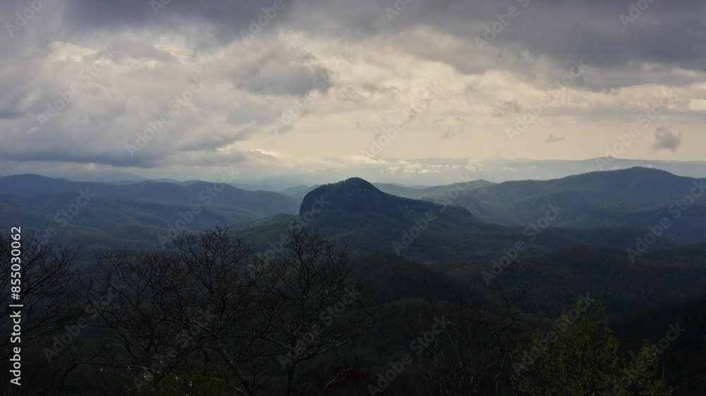 Moving through budding trees with Looking Glass Rock Asheville NC behind Moving through budding trees with Looking Glass Rock Asheville NC behind