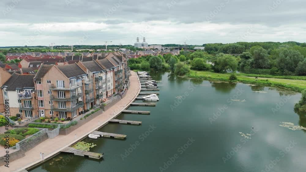 Pan shot of luxury and expensive apartments with yachts halted on lake in East Sussex England. Aerial view. Pan shot of luxury and expensive apartments with yachts halted on lake in East Sussex England. Aerial view.