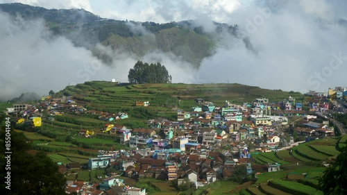 Aerial of Poombarai village covered in clouds in Kodai hills photo