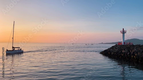 Sailing Boats Arriving at Howth Harbor at Golden Hour photo