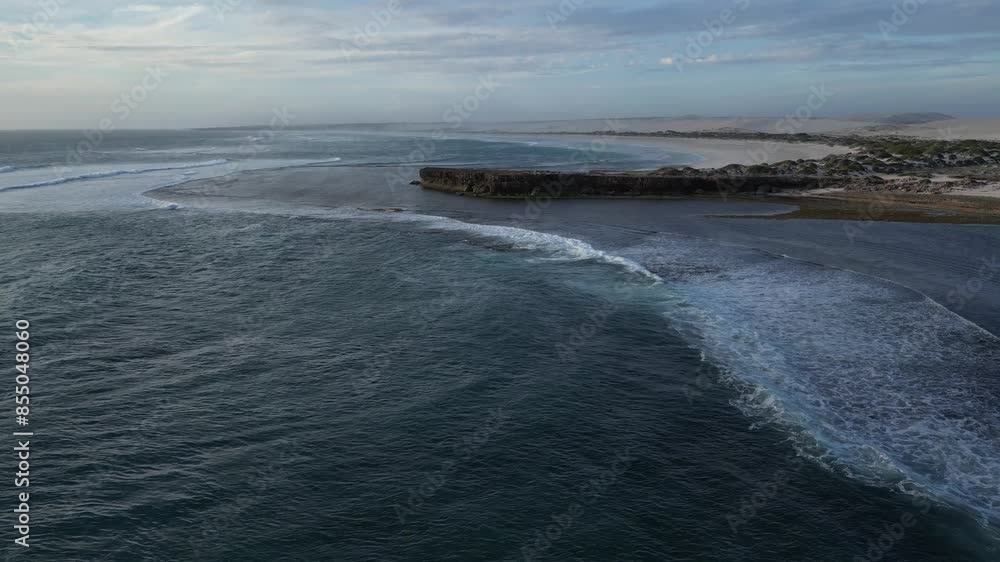 Aerial establishing shot of Cactus Beach with waves from ocean at sunset in Australia. Aerial establishing shot of Cactus Beach with waves from ocean at sunset in Australia.