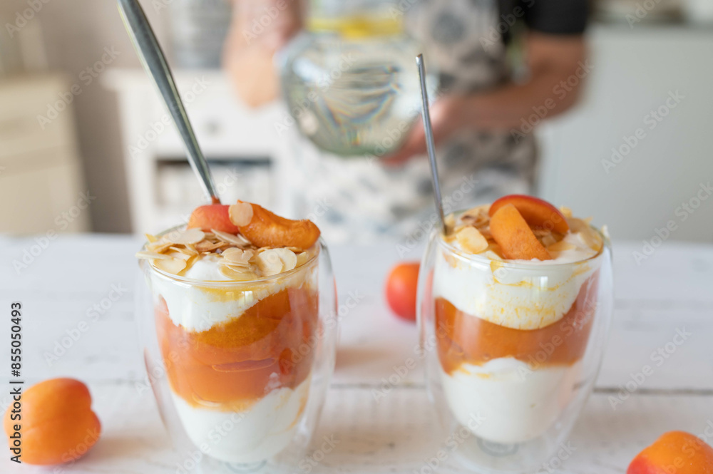 Homemade food with a healthy fruit dessert with quark and apricot compote and almond topping Homemade food with a healthy fruit dessert with quark and apricot compote and almond topping