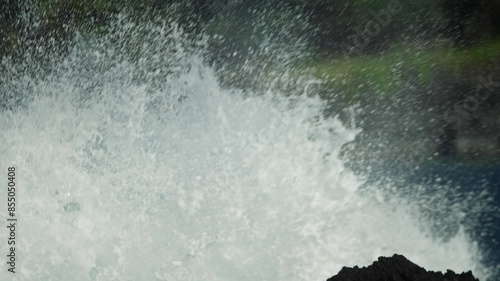 Wallpaper Mural Strong waves crash bursting up against black basalt lava rocks on coast in slow motion Torontodigital.ca