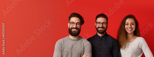 Smiling team on red background