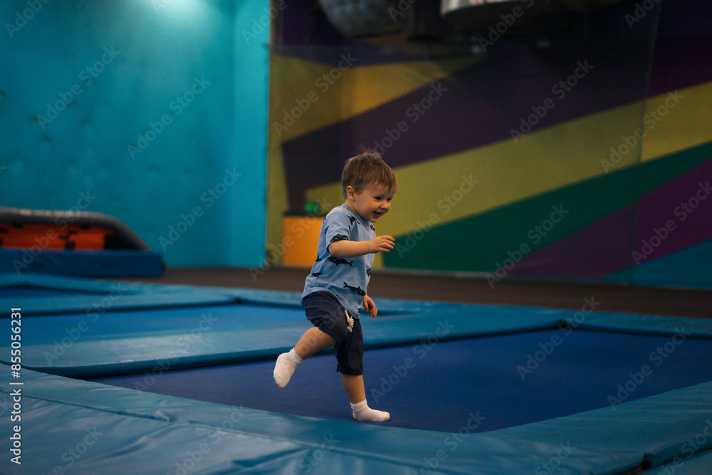 Сhild plays in an entertainment center, jumping on trampolines. Сhild plays in an entertainment center, jumping on trampolines.