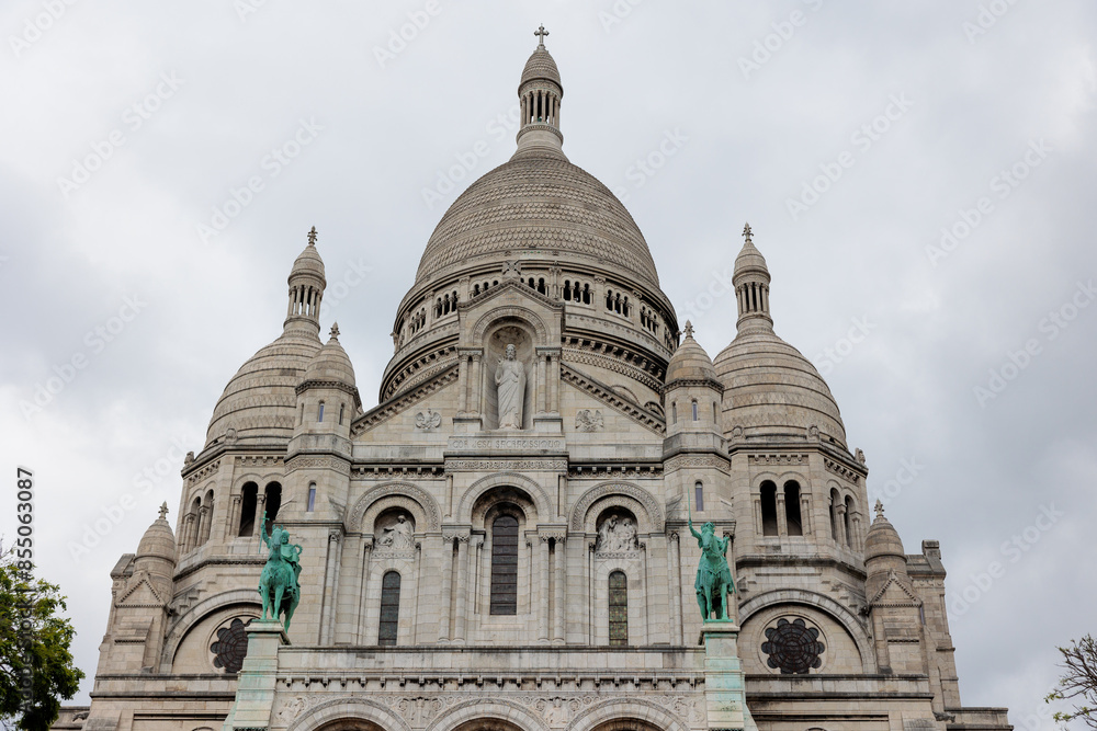 Sacré coeur basilica facade with domes and statues on overcast day in paris Sacré coeur basilica facade with domes and statues on overcast day in paris