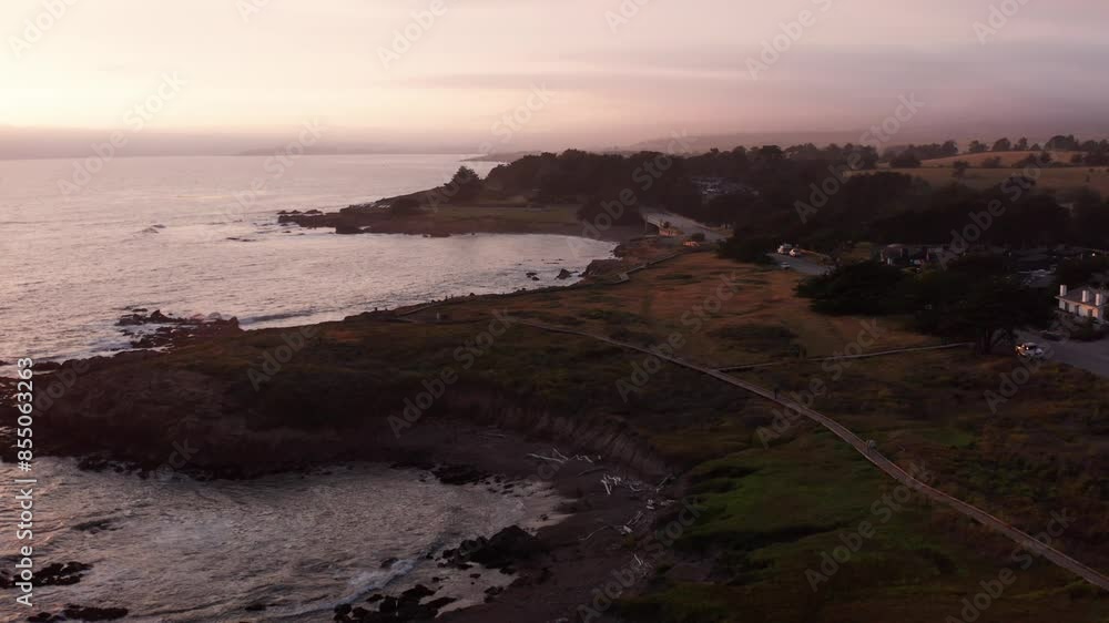 Descending close-up aerial shot of the nature boardwalk trail at Moonstone Beach during sunset in Cambria, California. 4K Descending close-up aerial shot of the nature boardwalk trail at Moonstone Beach during sunset in Cambria, California. 4K