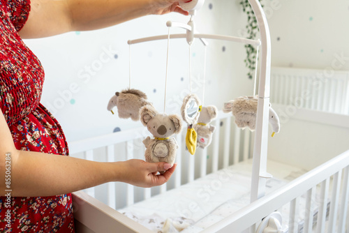 Photos Image of Expectant Mother Appreciating Plush Toy Mobile