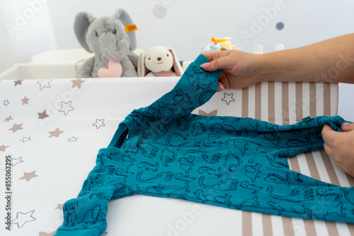 Organizing Baby Clothes: Folding a Onesie