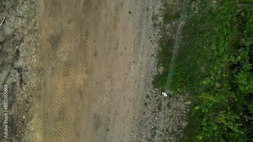 Wallpaper Mural Aerial drone top down shot over an empty dirt road with road been constructed on it at daytime. Torontodigital.ca