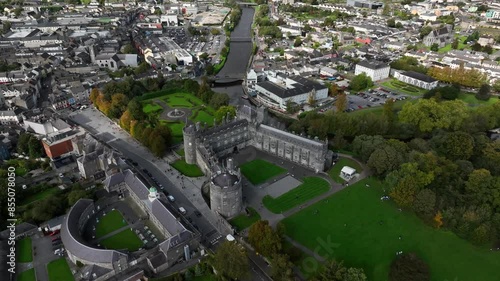 Kilkenny Castle, County Kilkenny, Ireland, September 2023. Drone orbits away from the historic building as shadows glide across the city with Saint Canice and Mary's Cathedrals in the background. photo