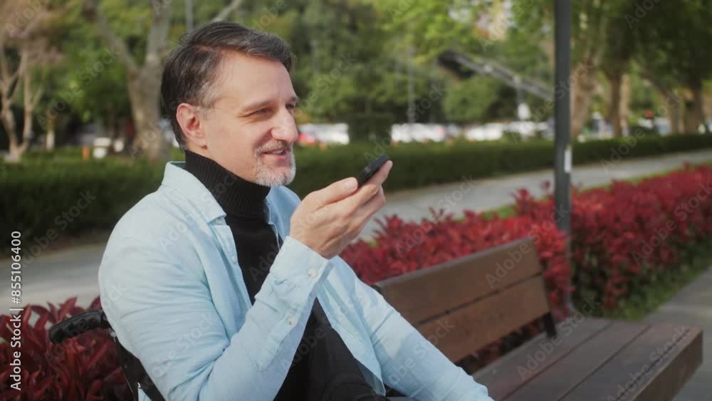 Disability handsome man recording voice message outdoor. Successful hispanic man uses mobile phone virtual assistant. Disability handsome man recording voice message outdoor. Successful hispanic man uses mobile phone virtual assistant.
