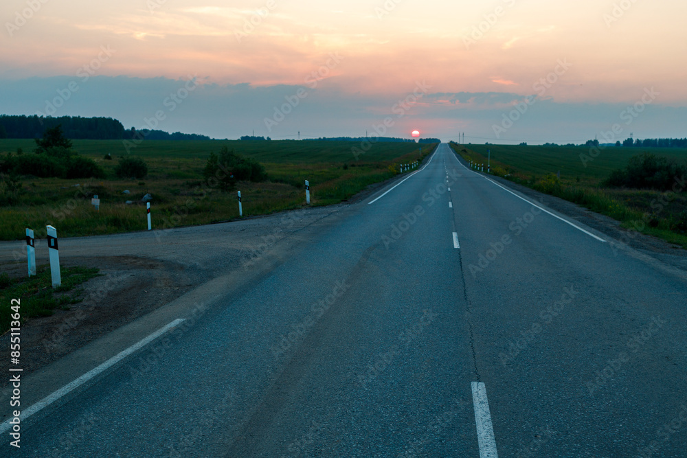 Fototapeta premium an asphalt road leading to the horizon