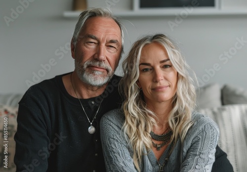 Older Man and Woman Relaxing Together on a Couch in a Modern Home