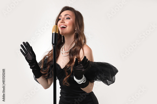 Wallpaper Mural Beautiful young woman in stylish dress with microphone singing on light grey background Torontodigital.ca