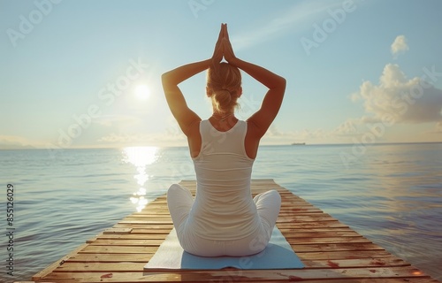 Woman Practicing Yoga on Wooden Dock During Sunrise at the Beach