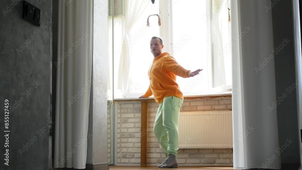 Ballet or contemporary dance lesson at home. Classical ballet exercises of a young man. The athlete will perform a squat exercise. Ballet or contemporary dance lesson at home. Classical ballet exercises of a young man. The athlete will perform a squat exercise.