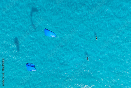 Summer holidays. Sports team. Kitesurfing on a sunny summer day. Extreme sports. Sea surface of water. Azure sea and warm weather. © biletskiyevgeniy.com