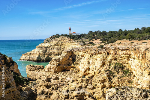 Portuguese coast in Benagil, Algarve, Portugal. Alfanzina Lighthouse. Seven Hangging Valleys Trail. photo