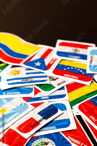 High angle view of different latin america country flag stickers with copy space on table
