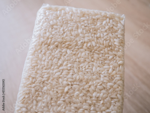 Packaging of rice for making risotto. Vacuum packed to preserve the quality of rice grains. A modern way to store cereals. Rectangular packaging for placing inside a cardboard box. photo