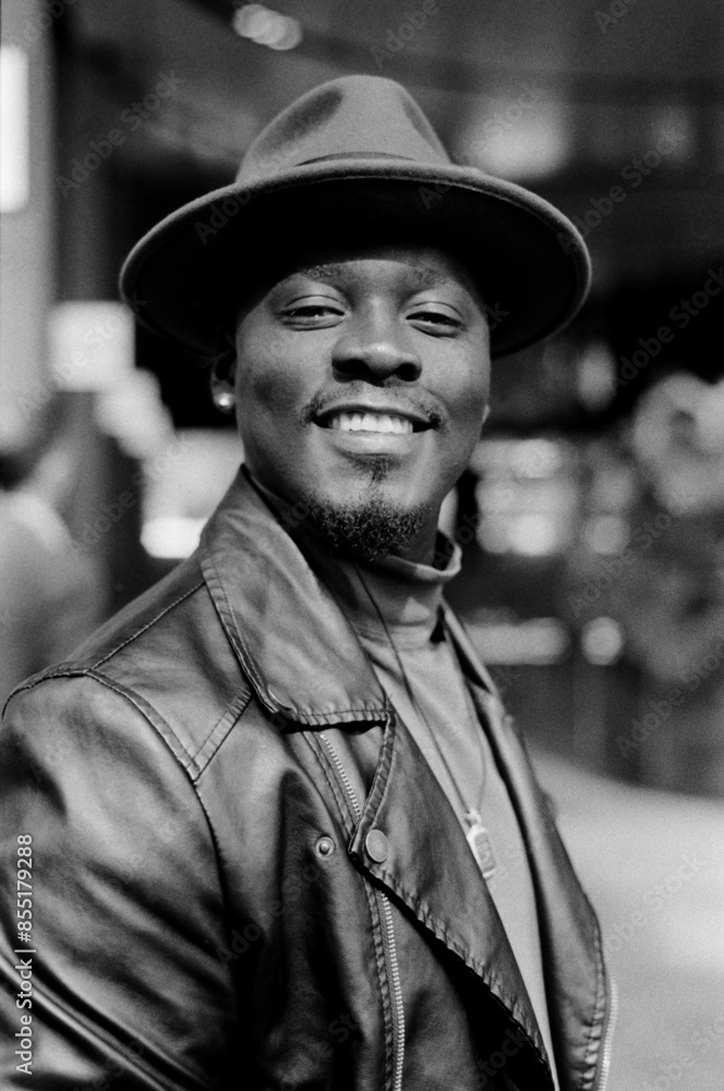 Smiling man in monochrome portrait is looking at camera in friendly portrait. Smiling man in monochrome portrait is looking at camera in friendly portrait.