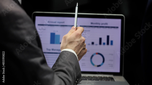 Wallpaper Mural Businessmen discuss a business plan in close-up in a dark office Torontodigital.ca
