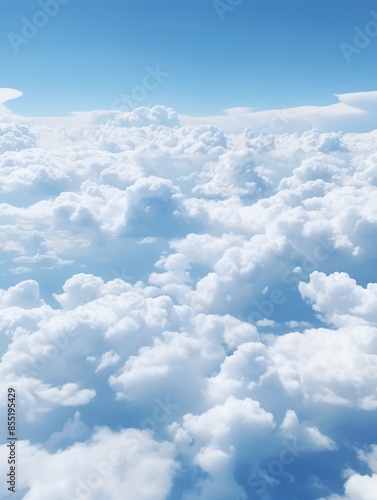 A view of fluffy white clouds through an airplane window photo