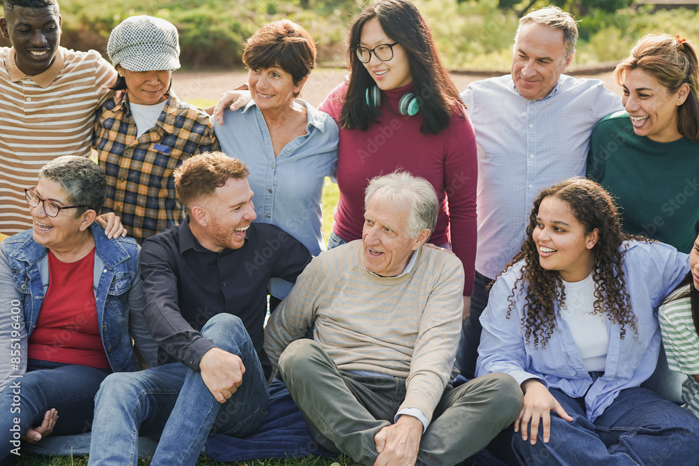 Fototapeta premium Group of multi generational people having fun together at city park - Multiracial friends outdoor - Community and social inclusion concept