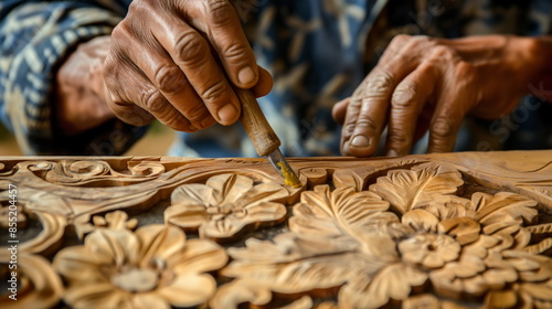 close-up of a carpenter meticulously carving intricate designs into a wooden surface
