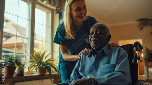 Nurse assisting elderly man in wheelchair. photo