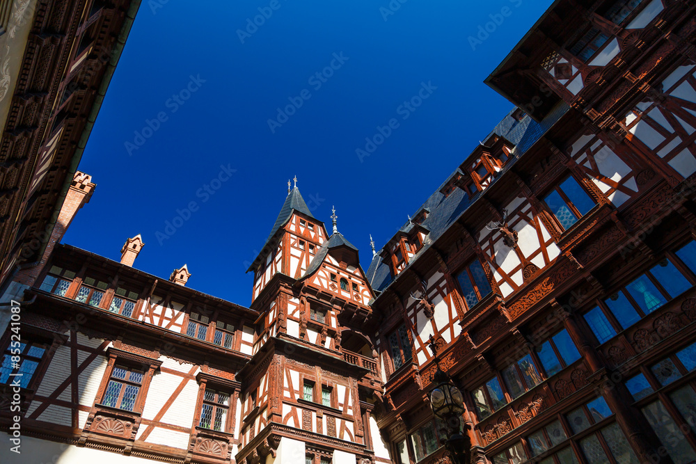 The interior courtyard facades of The Peles castle decorated with fachwerk similar to that seen in northern European alpine architecture. The town of Sinaia, Carpathian Mountains, Romania The interior courtyard facades of The Peles castle decorated with fachwerk similar to that seen in northern European alpine architecture. The town of Sinaia, Carpathian Mountains, Romania