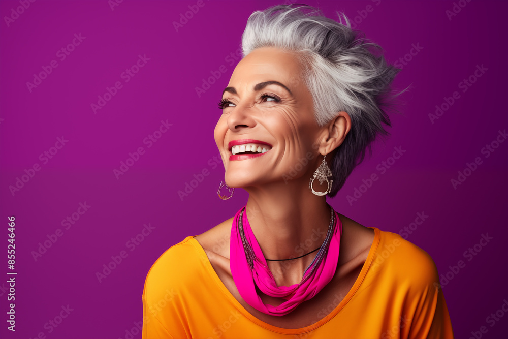 Mature middle aged stylish modern woman wearing bright colored neon cloths in bright single color background, smiling happy woman wearing stone embedded jewelries. good health with good skin care Mature middle aged stylish modern woman wearing bright colored neon cloths in bright single color background, smiling happy woman wearing stone embedded jewelries. good health with good skin care