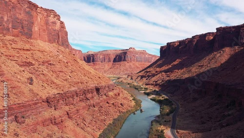 Travel by car through national parks of USA with picturesque landscapes of nature. Flying over Colorado River in rocky gorge of red canyon similar to Grand Canyon. Moving forward to an unknown goal