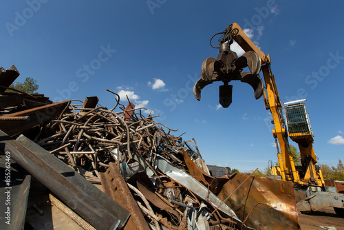Excavator for loading scrap metal.