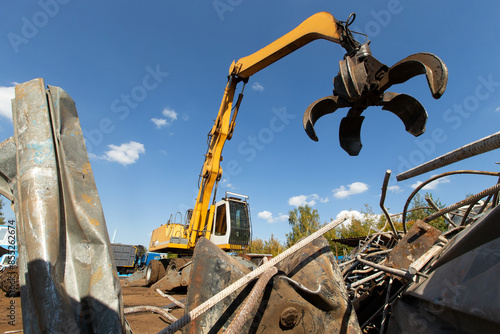 Excavator for loading scrap metal.