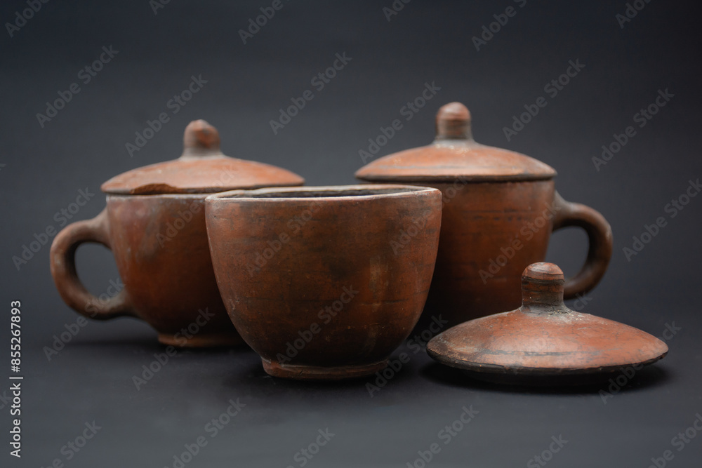 three traditional tea cups made of wood, can also be used to drink coffee with a black background three traditional tea cups made of wood, can also be used to drink coffee with a black background