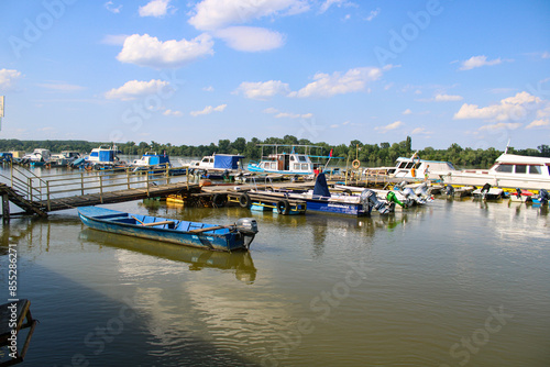 Boat dock on the green Danube on a sunny day in June - location Stari Slankamen, Vojvodina Province, Serbia photo