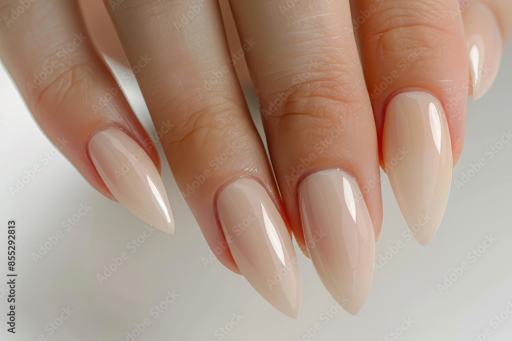 Elegant hand with manicured nude stiletto nails Elegant hand with manicured nude stiletto nails