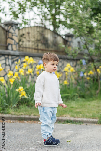 Curious toddler exploring garden pathway © Olha Tsiplyar
