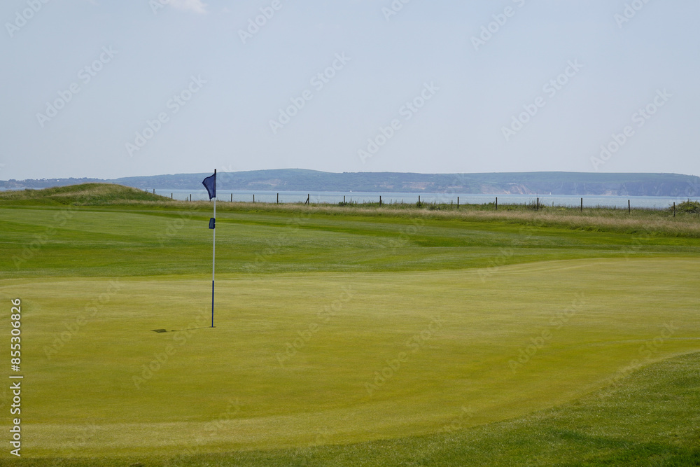 golf course with sea view. golf hole green with flag. sport and leisure activities golf course with sea view. golf hole green with flag. sport and leisure activities