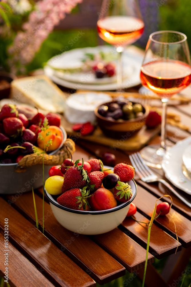 Beautiful romantic outdoor wedding decor in a field. Table decorated with purple lupines flowers. Wineglasses with white wine. Sunset, summer, golden hour. Perfect surprise date for loving couple Beautiful romantic outdoor wedding decor in a field. Table decorated with purple lupines flowers. Wineglasses with white wine. Sunset, summer, golden hour. Perfect surprise date for loving couple