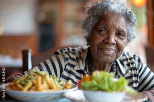 Senior woman smiling sitting at restaurant table with healthy food