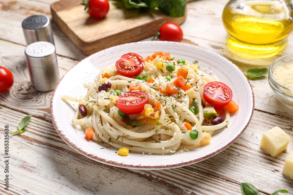 Plate with tasty pasta primavera on white wooden background Plate with tasty pasta primavera on white wooden background